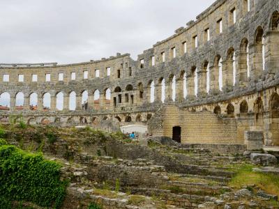 Explore the historic Roman amphitheater ruins in Pula, a major tourist attraction in Croatia.