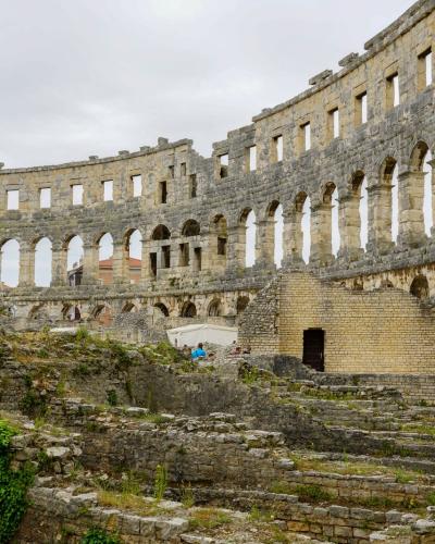 Explore the historic Roman amphitheater ruins in Pula, a major tourist attraction in Croatia.