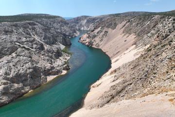 Free Stunning aerial view of the Zrmanja River winding through a rocky canyon under a clear blue sky. Stock Photo
