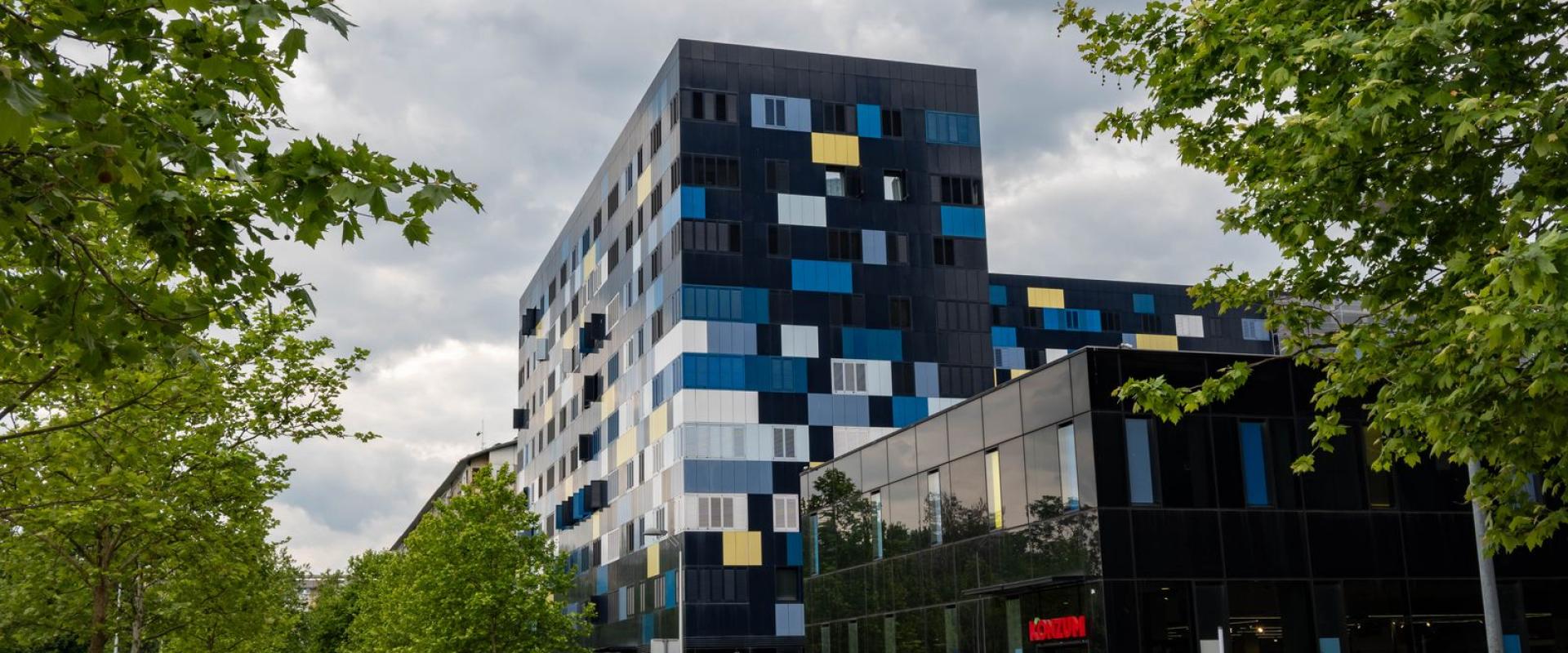Contemporary apartment buildings along a street in Zagreb, Croatia, showcasing modern urban design.