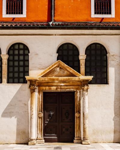 Ornate stone doorway of a historic church in sunny Zadar, Croatia.