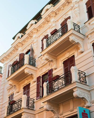 Stunning view of elegant Croatian architecture in Opatija, showcasing ornate balconies and sunset lighting.