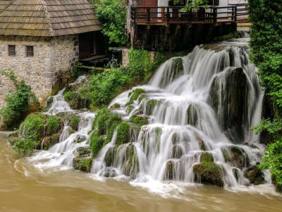 Captivating waterfall next to an old mill in Slunj, showcasing natural beauty and Croatian heritage.