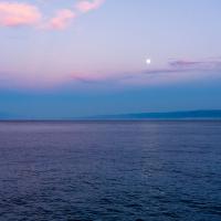 Serene seascape at sunset over the ocean in Croatia with pastel skies and calm waters.