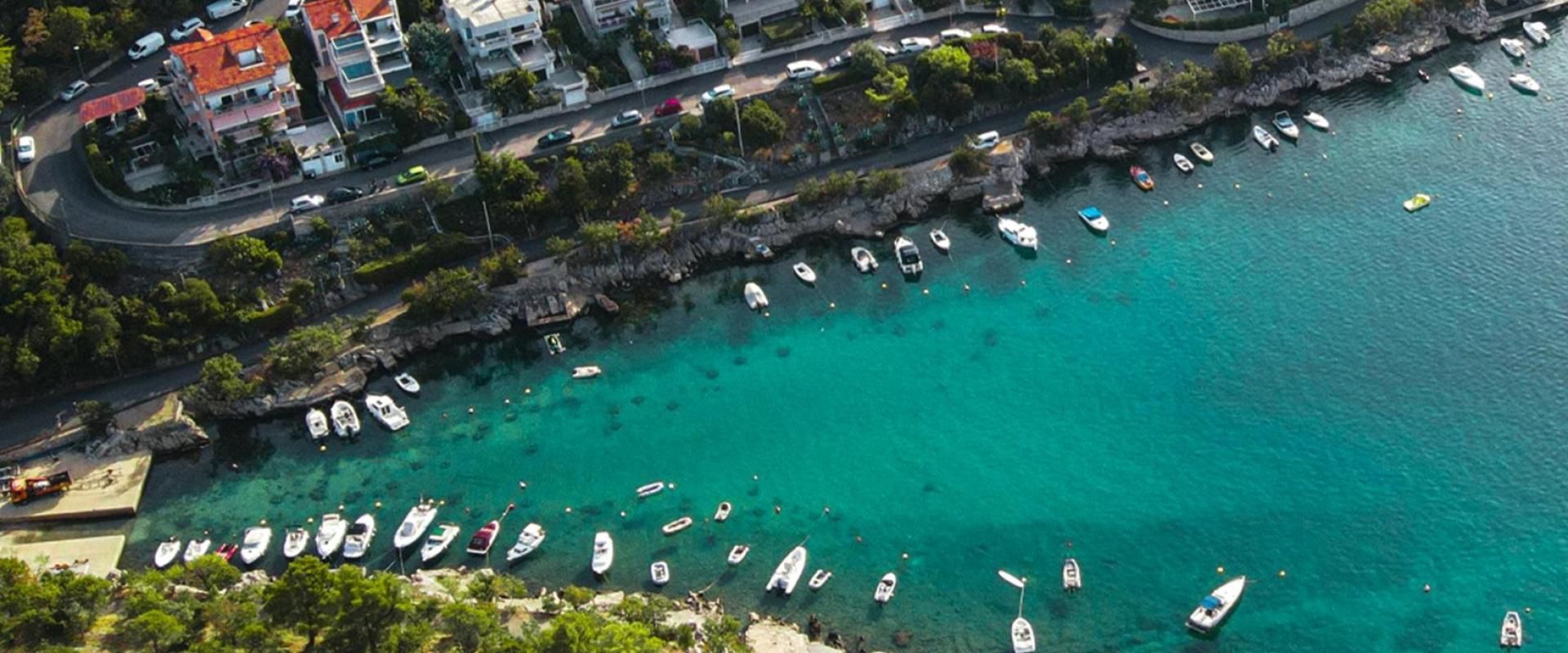 Stunning aerial view of Dramalj's coastline with yachts and vibrant greenery in Croatia.